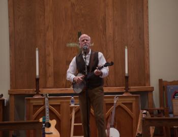 John McCutcheon performed with banjo and assorted other instruments. John McCutcheon performed with banjo and assorted other instruments.