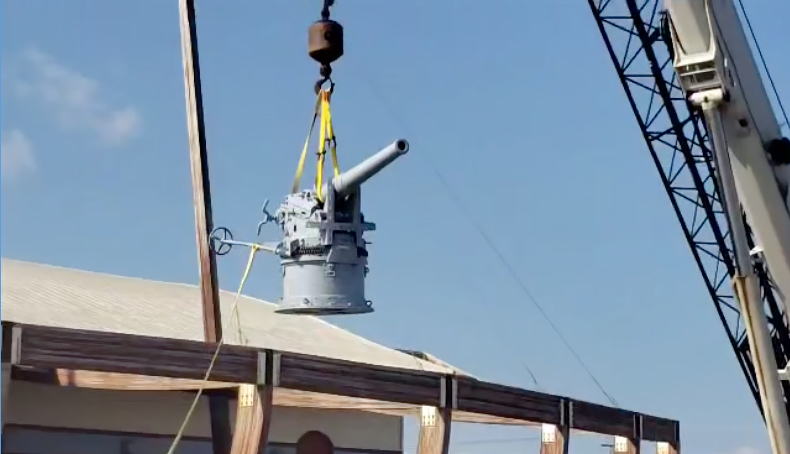 German WWI 88 millimeter cannon is hoisted into place at the Graveyard of the Atlantic Museum.