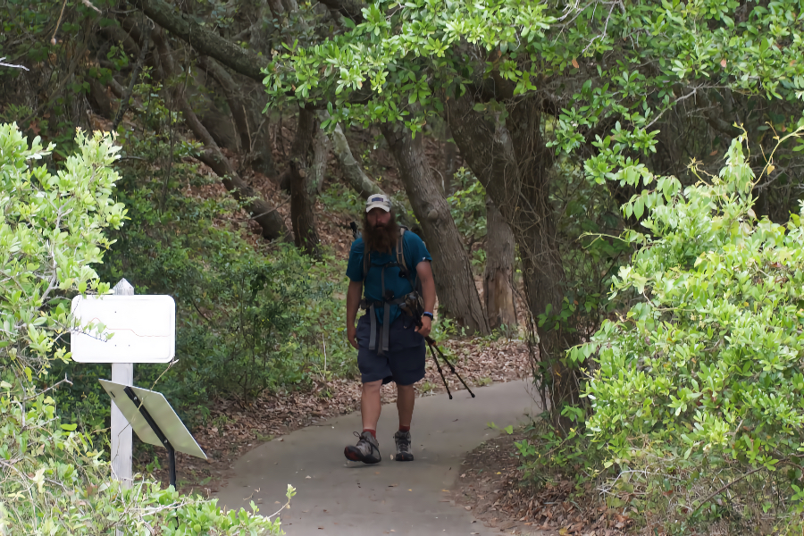 Ending his 1175 mile trek, Trail Marshall emerges from Jockey's Ridge foliage. Ending his 1175 mile trek, Trail Marshall emerges from Jockey's Ridge foliage.